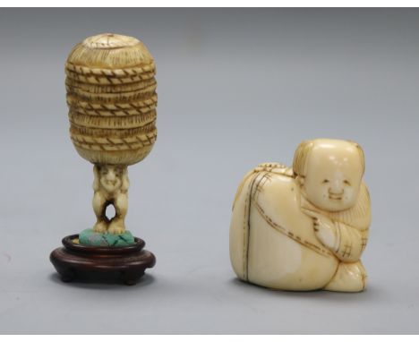 A late 19th century Japanese walrus ivory netsuke of a boy and sack and an ivory netsuke of a man carrying a bale