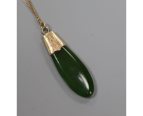 A yellow metal mounted jade pendant, on a 9ct gold fine link chain, pendant 42mm.