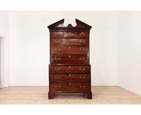 A George III mahogany chest on chest,mid-18th century and later, the architectural pediment with Greek key moulding and Chine