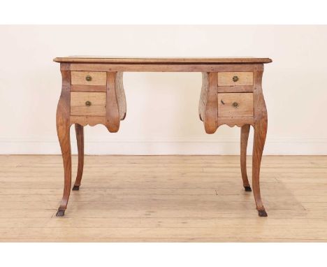 A stripped walnut writing table,18th century, Italian, the moulded rectangular top above two banks of drawers, raised on squa