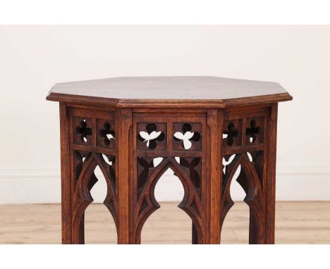 An Islamic-style oak octagonal table by Liberty &amp; Co.,c.1900, the moulded top raised on pierced supports in the Gothic ta