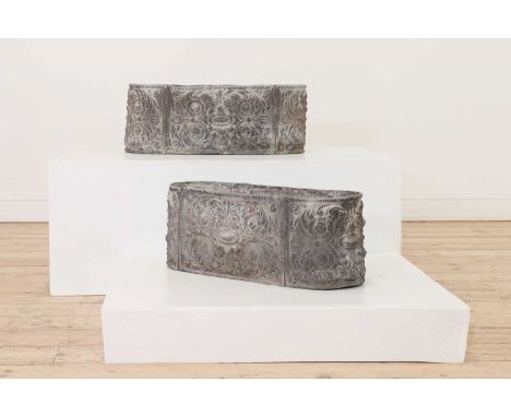 A pair of lead trough planters,probably early 20th century, each of oval form with central patera and all-over scrolling acan