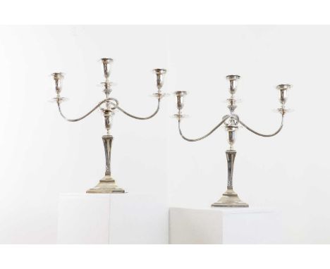 A pair of silver three-light candelabra,by Mappin &amp; Webb, London 1921, the central light and two reeded branches with fol