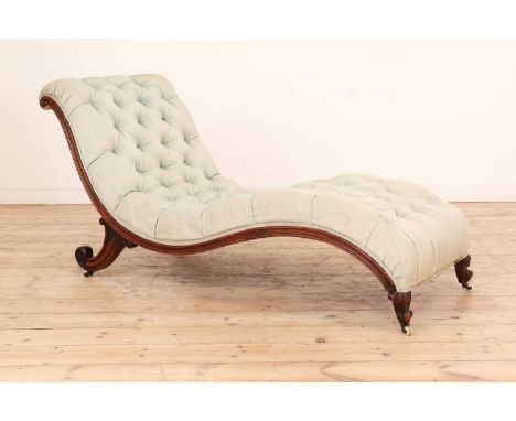 A Victorian walnut chaise longue,of 'S' scroll shape with deep buttoned upholstery, raised on scrolling foliate supports term