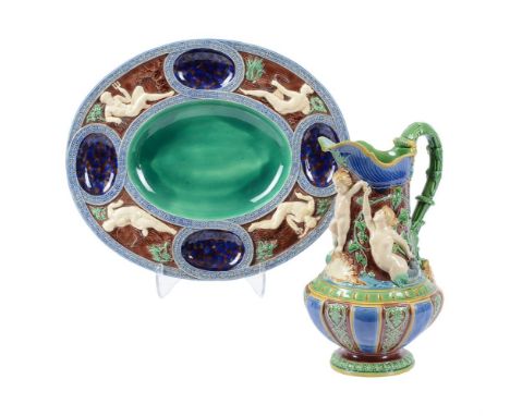 A MINTON MAJOLICA PITCHERTHIRD QUARTER 19TH CENTURYDecorated with putti and TritonsImpressed marks30cm highTogether with a Mi