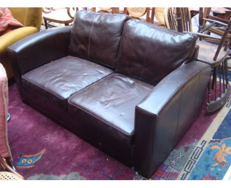 A modern brown leather two seater sofa. 