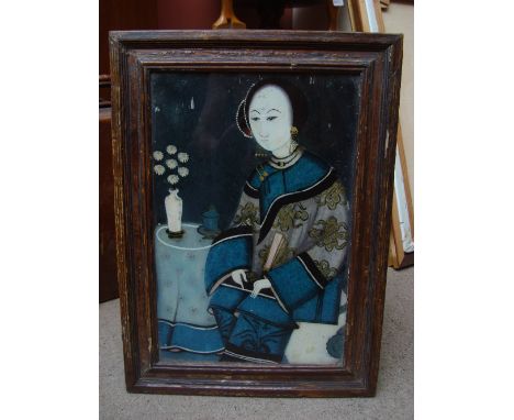 A reverse painted Chinese portrait of a seated woman. 