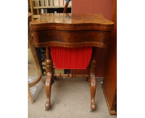 A 19th Century veneered games/work table, the swivel flapped top opening to reveal chess/cribbage and backgammon boards. 