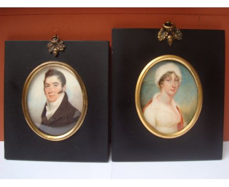 A poss pair of early 19th Century portrait miniatures on ivory, in later frames. 