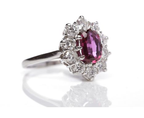 RUBY AND DIAMOND CLUSTER RINGthe central oval ruby 7.7x5.8mm surrounded by diamonds totalling approximately 0.80 carats, in p