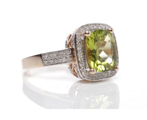 PERIDOT AND DIAMOND RINGthe central peridot of approximately 3.20 carats in a diamond setting, on diamond set shoulders, in f
