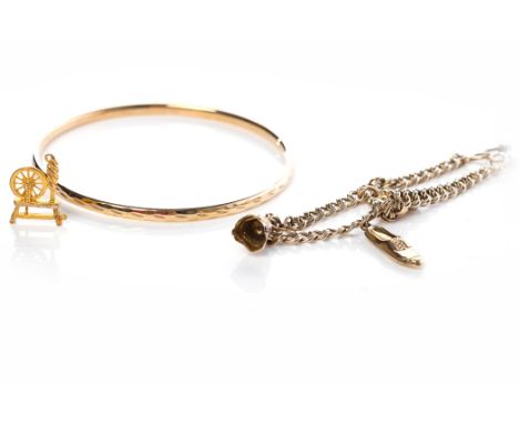 NINE CARAT GOLD CHARM BRACELETwith charms including a shoe and a thimble; together with a nine carat gold bangle, 13.8g gross