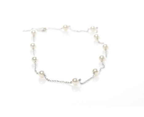 MIKIMOTO EIGHTEEN CARAT WHITE GOLD AND PEARL NECKLACEformed by sections of chain, set with spherical white pearls