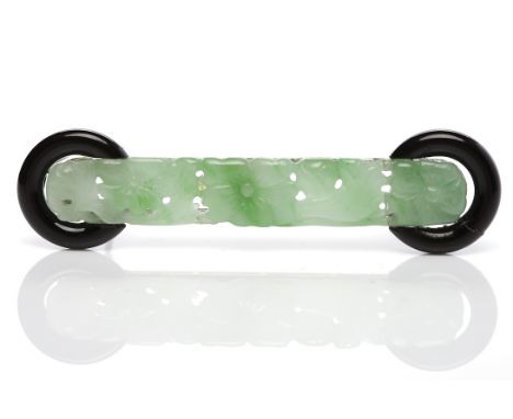 ART DECO JADE AND ONYX BROOCHformed by a carved and pierced section of jade with floral motifs, the terminals with circular o