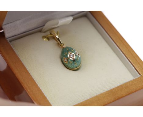 HOUSE OF FABERGE ENAMEL AND DIAMOND EGG PENDANTnumbered 127/500, set with three brilliant cut diamonds, finished in green ena