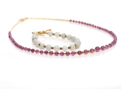 RUBY NECKLACEformed by faceted graduated rubies, on silver gilt; along with a jadeite bracelet, with silver gilt clasp (2)