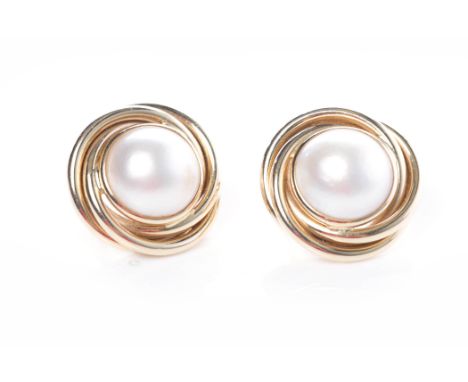 IMPRESSIVE PAIR OF MABE PEARL EARRINGSeach set with a central white pearl approximately 15mm diameter, in a twist border, unm
