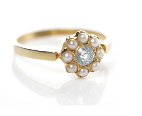 EARLY TWENTIETH CENTURY EIGHTEEN CARAT GOLD BLUE GEM AND SPLIT PEARL RINGthe central blue gem surrounded by split pearls