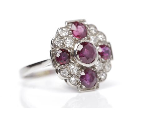 EDWARDIAN RUBY AND DIAMOND RINGthe scalloped round bezel 17mm across with five rubies and grain set diamonds totalling approx