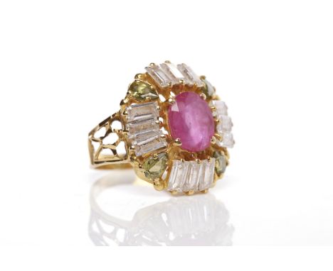 IMPRESSIVE RUBY, PERIDOT AND WHITE GEM SET RINGset with a central oval ruby, surrounded by white gems and marquise shaped per