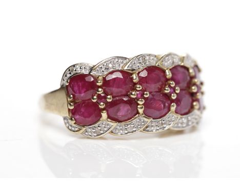 RUBY AND DIAMOND DRESS RINGset with a two rows of oval rubies, flanked by brilliant cut diamonds, in nine carat gold, size R-