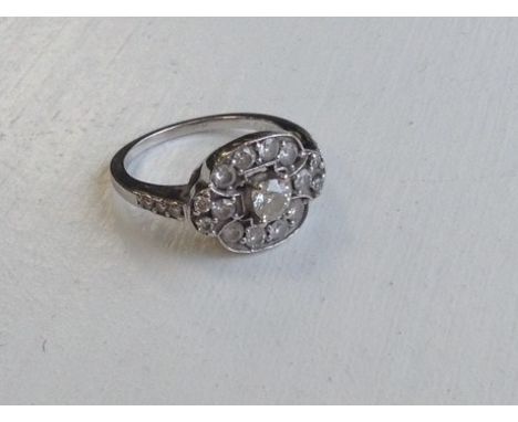 FINE ART DECO STYLE DIAMOND RINGthe pierced bezel set with a central brilliant cut diamond of approximately 0.30 carats and f