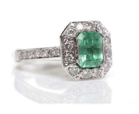 ART DECO STYLE EMERALD AND DIAMOND RINGthe emerald cut emerald of approximately 1.27 carats surrounded by diamonds and on dia