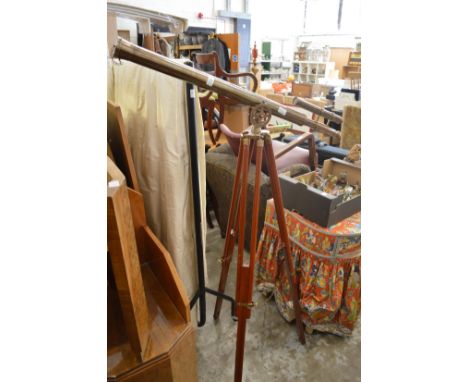 Brass telescope on tripod stand.