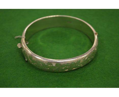 A silver bangle.