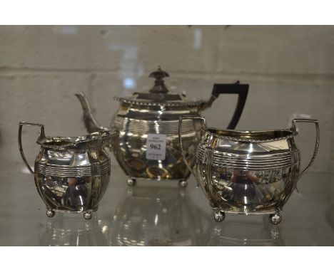 A silver three piece tea service.