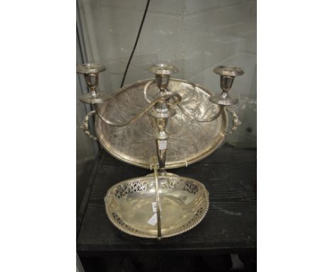 A plated swing handle basket, three light candelabra and twin handled tray.