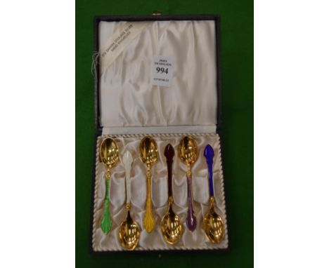 A cased set of six Scandinavian silver gilt and enamel decorated coffee spoons.