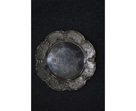 A Stirling silver dish with engraved shaped border.