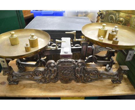 A good set of cast iron scale with brass pans and weights.