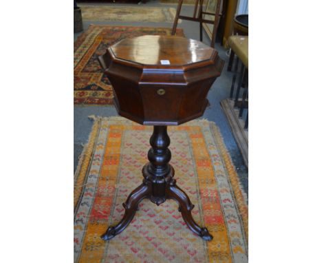 A 19th century rosewood teapoy on tripod base.