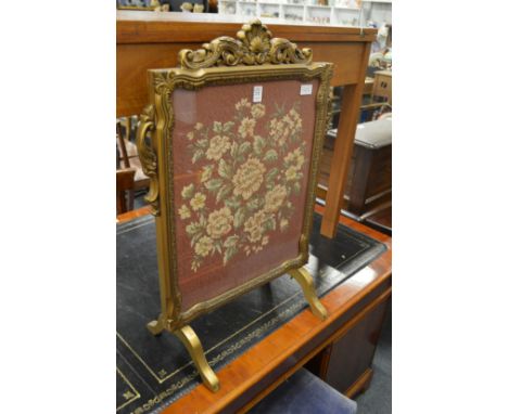A gilt framed needlework firescreen.