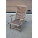 A folding steamer style armchair (lacking foot rest).