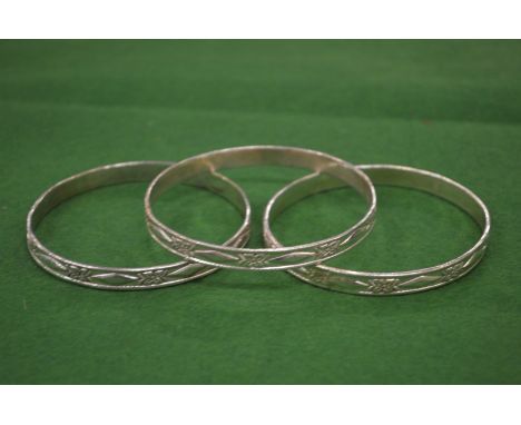 Three engraved silver bangles.
