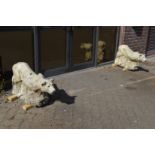 A good pair of reconstituted stone garden ornaments modelled as prowling lions.