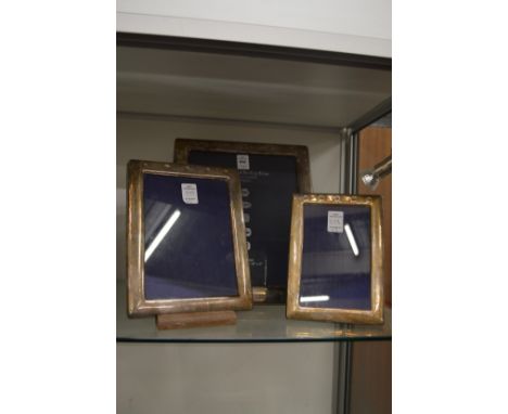 A set of three Hallmark silver photograph frames.