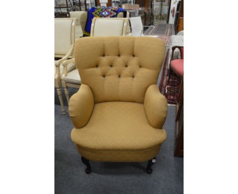 A modern button upholstered armchair.