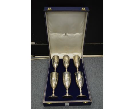 A cased set of nine Asprey & Co silver wine goblets, engraved with initials.