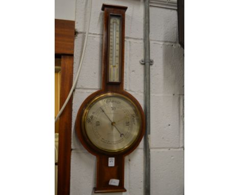 A mahogany cased barometer/thermometer.
