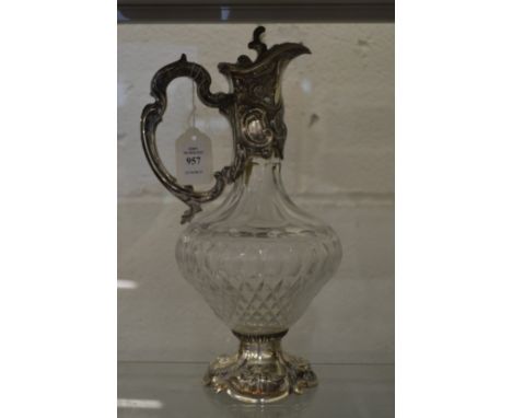 A good cut glass claret jug with embossed silver mounts.