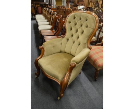 A Victorian button upholstered mahogany framed armchair.