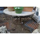 A faux marble circular patio table with wrought iron base.