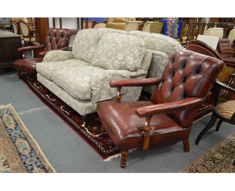 A good pair of red leather button upholstered open armchairs.