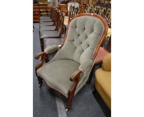 A Victorian button upholstered mahogany framed armchair.