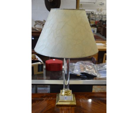 A brass and perspex lamp.