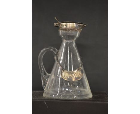 A silver mounted whiskey tot with whiskey label.